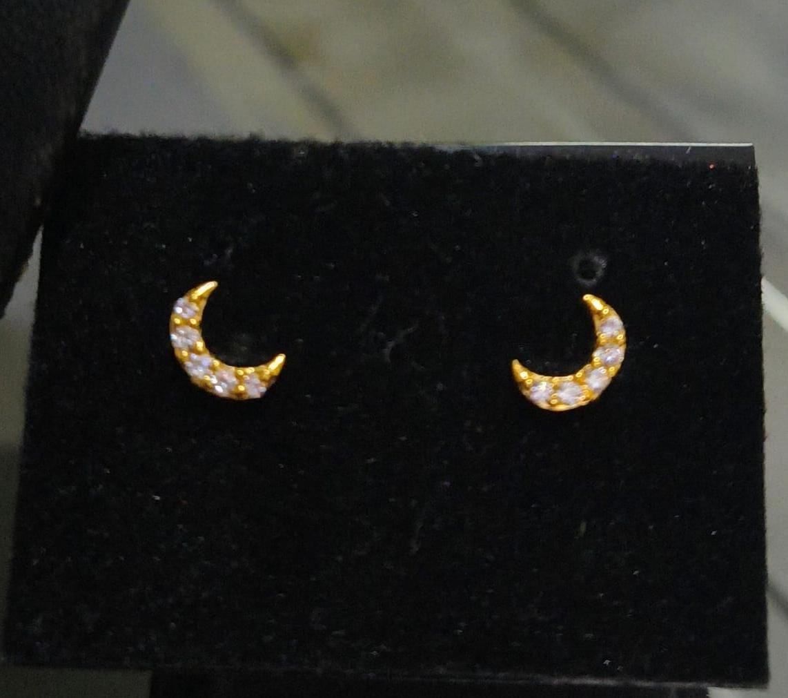 Half-moon shaped small size white stone and red stone nose pin and second stud