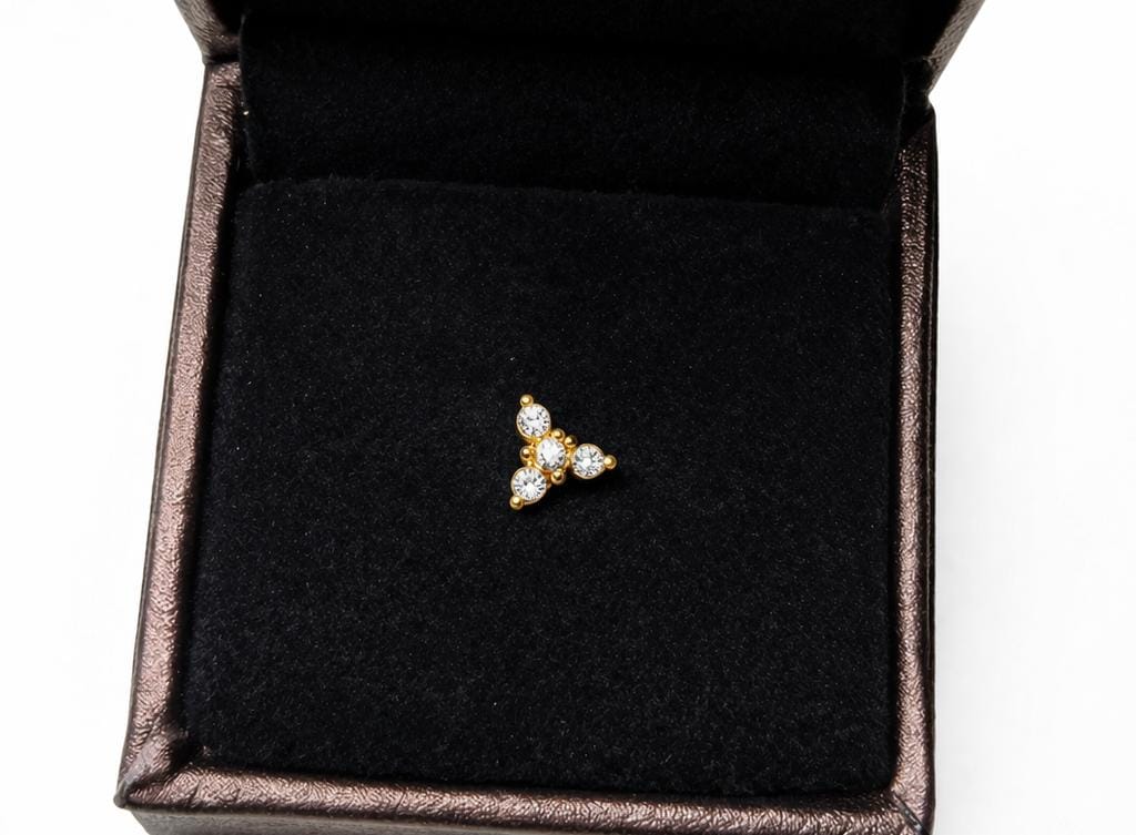 Three leaf designed simple stone nose pin available in gold covering